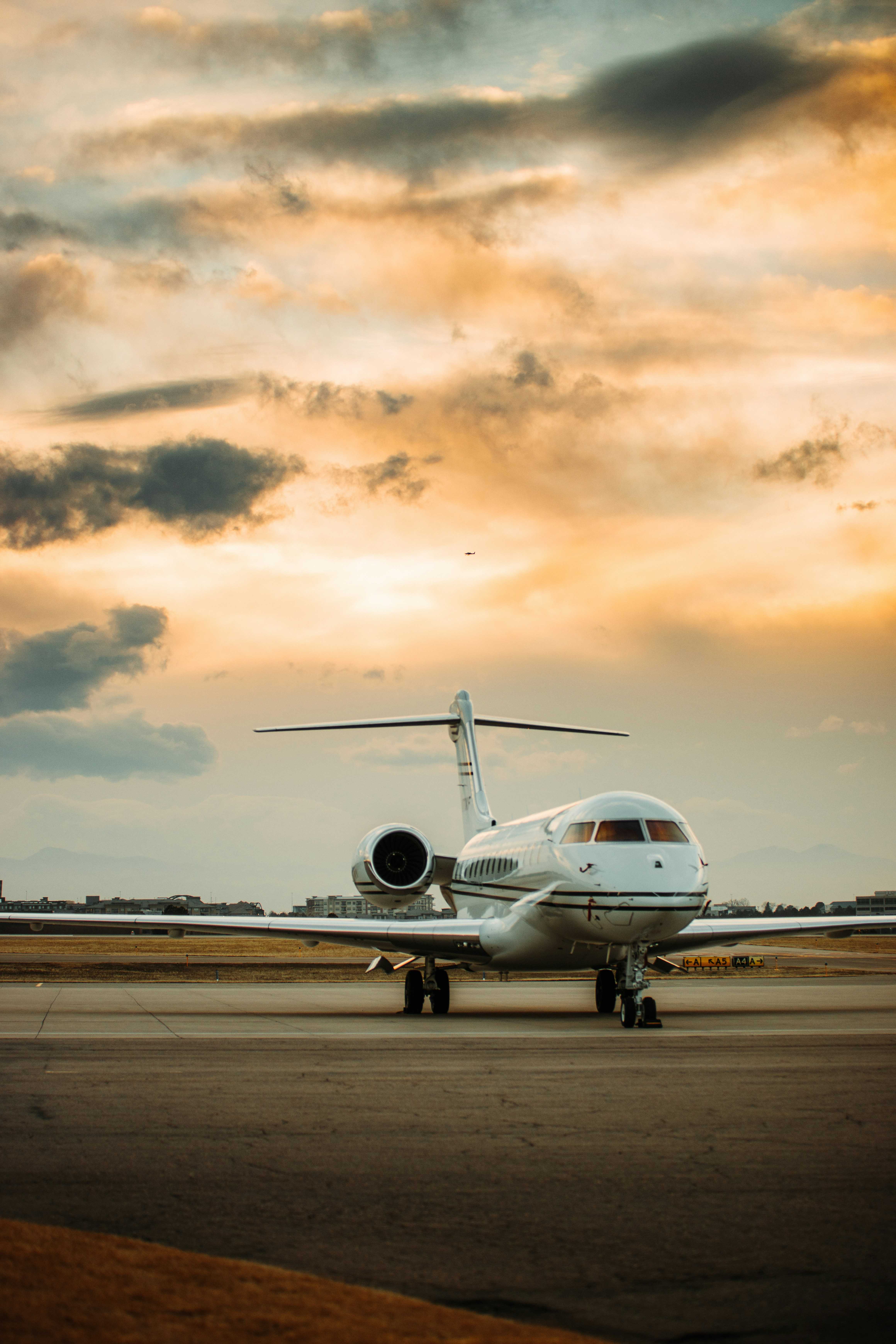 Global business jet on the ramp at sunset